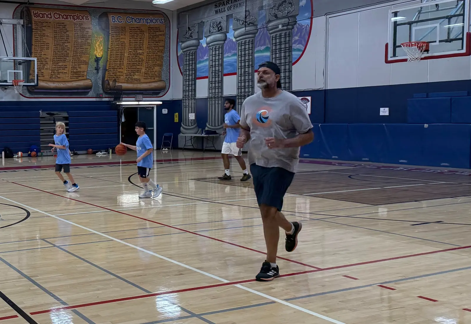 Coach Lucky Walia on the court with young athletes